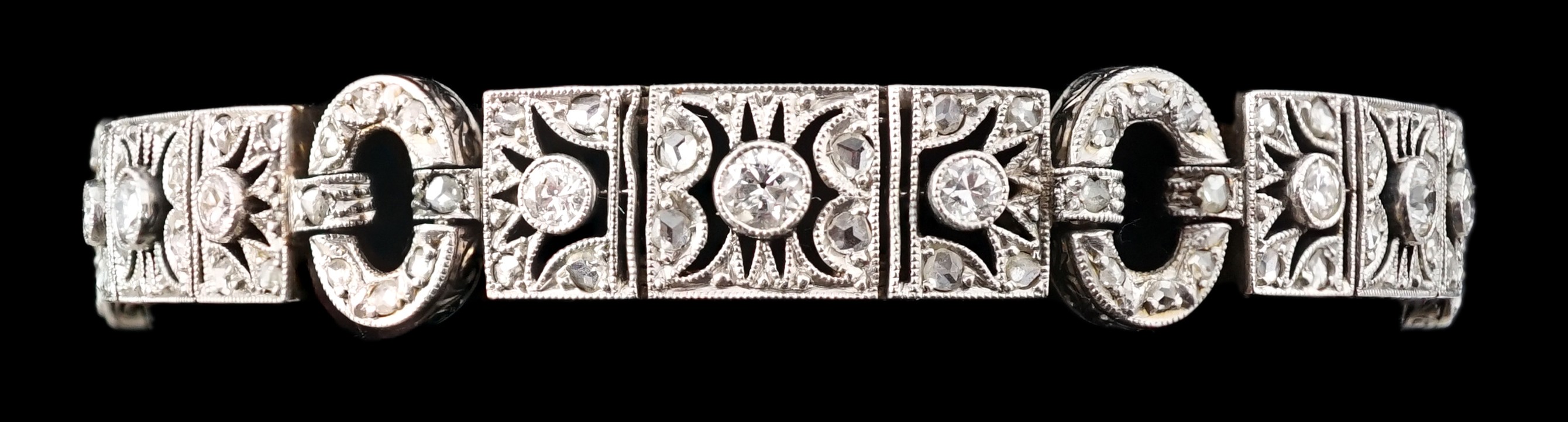 A 1920's pierced 18ct white gold and millegrain set round and rose cut diamond cluster bracelet